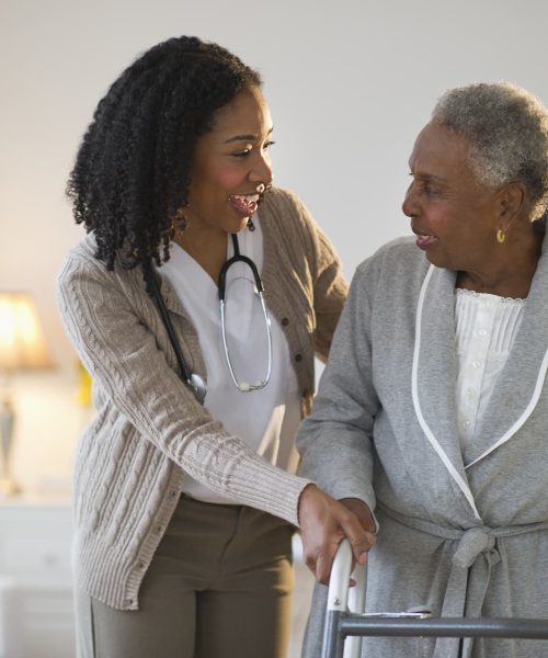 Nurse with elderly woman with walker